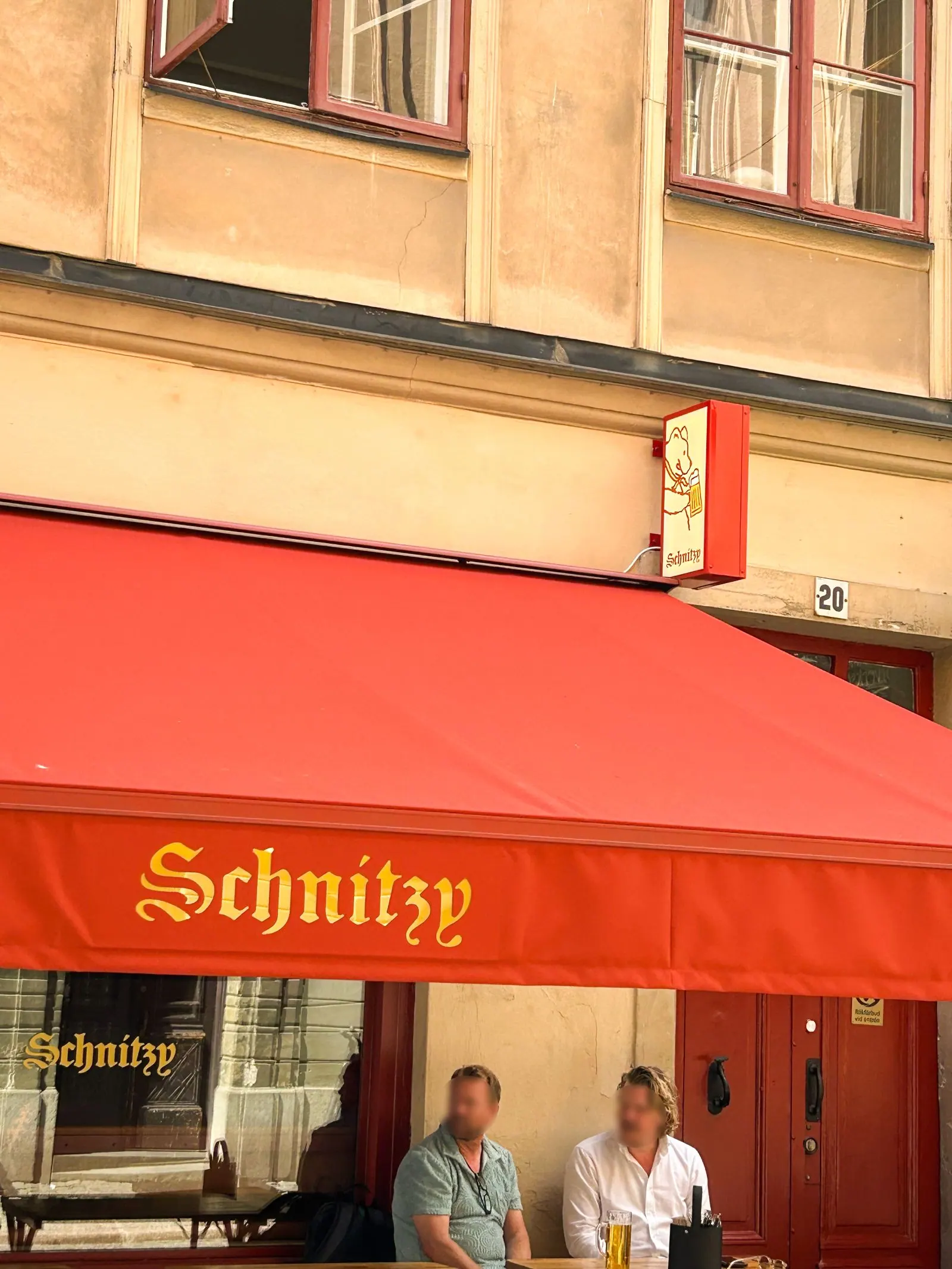 Patio awning with LED-lit logo over Schnitzy's outdoor dining area