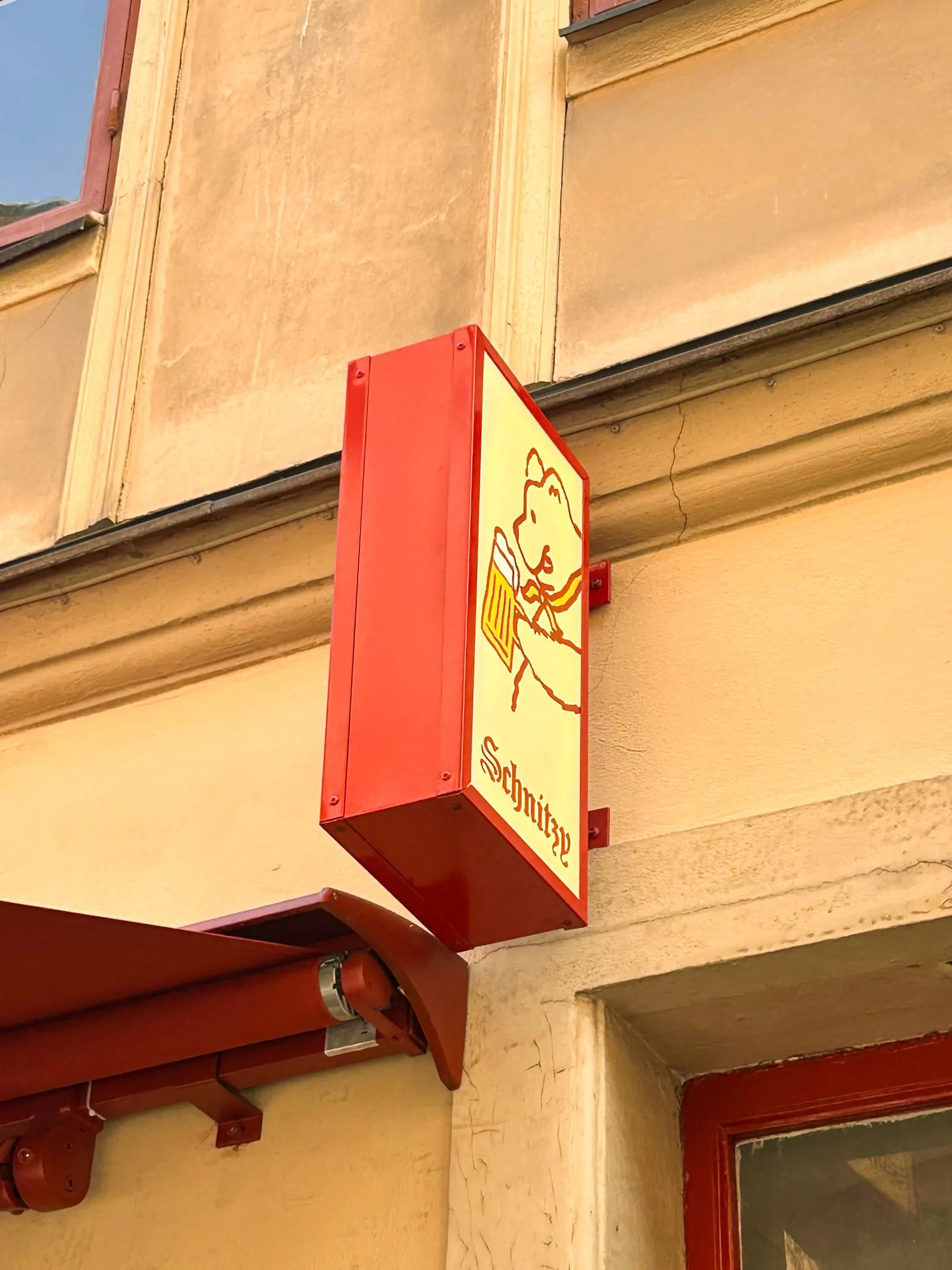 Schnitzy's entrance in Gamla Stan in evening light with illuminated signage